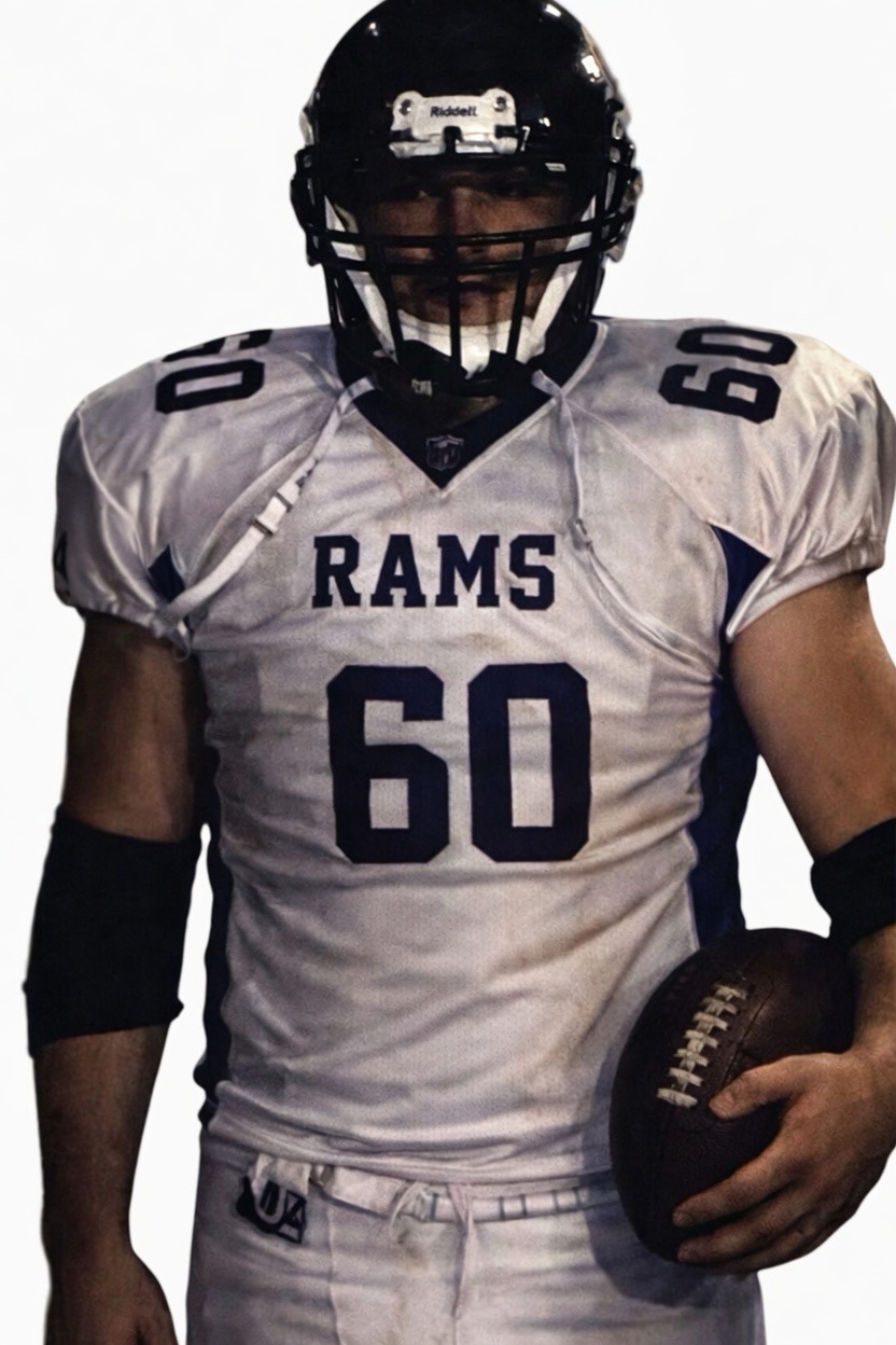 Kenney Aicher in his number 60 Rams football uniform holding a football